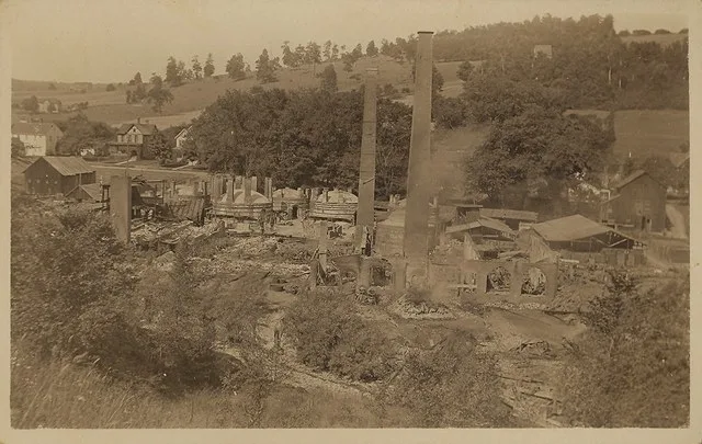 Postcard picture of the aftermath of a fire that destroyed the Terra Cotta Tile Co. factory in Alfred, New York. Smoke can be seen in the middle of the picture; eBay store Web pag...