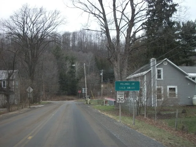A sign along Herkimer County Route 224 entering the village of Cold Brook, New York.