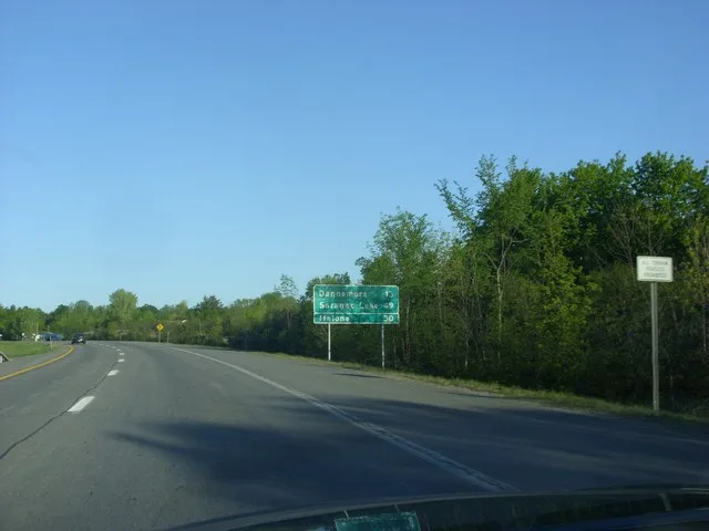 Sign denonating Route 374's arterial distance from Dannemora, NY