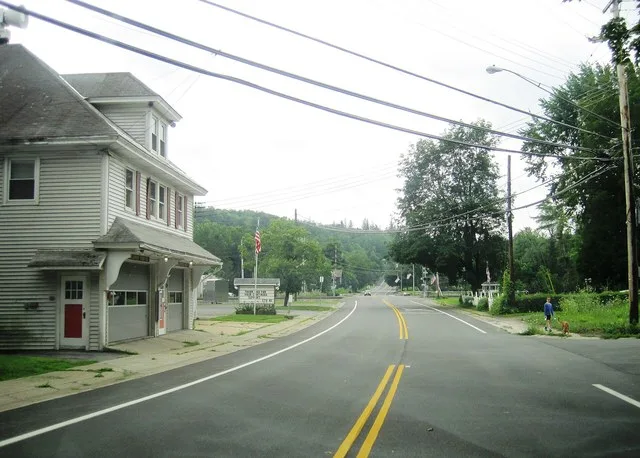 Photo of southbound New York State Route 395 (Main Street) in the village of Delanson , New York . Photo taken looking south at the intersection with Thousand Acre Road.