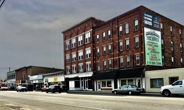 A view of East Main Street in downtown Falconer, New York - specifically the north side thereof, just east of Work Street - in April 2021.