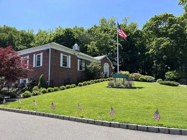 Flower Hill Village Hall in the Inc. Village of Flower Hill, NY on May 26, 2023, with flags on the perimeter of the lawn in celebration of Memorial Day. Located at 1 Bonnie Height...