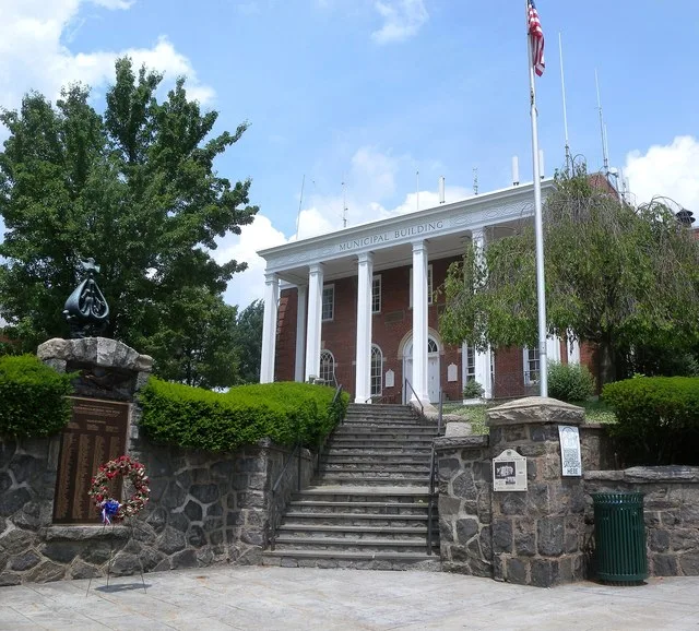 Looking north at Hastings-On-Hudson Municipal Building on a mostly sunny midday.