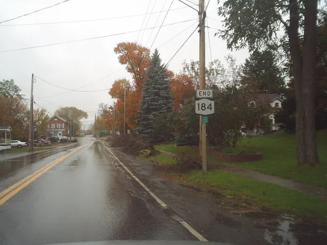 New York State Route 184 approaching its terminus at New York State Route 812 in Heuvelton, which is visible in the far distance.
