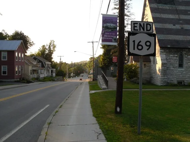 New York State Route 169 approaching its terminus at New York State Routes 28 and 29 in Middleville. The rather large end sign is not up to standards on the shield on the highway.
