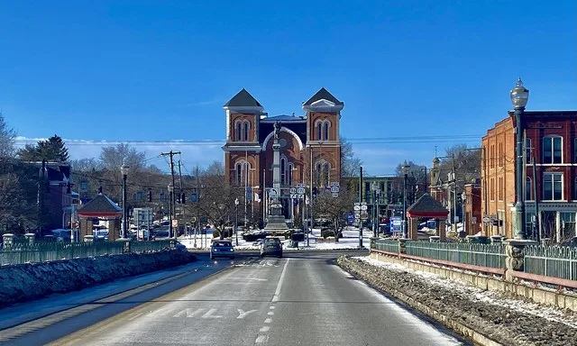 Courthouse Square in central Owego, New York, as seen from near the crest of the Court Street Bridge over the Susquehanna River on a February 2022 evening. The square has been the...