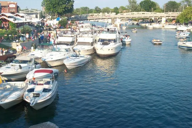 A number of boats are docked to the North Tonawanda side of Gateway Harbor during a summer Canal Concert. This image was uploaded by Brandon Peterman , the photographer.
