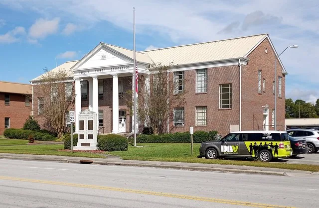 Pamlico County Courthouse in North Carolina. Flag is at half-staff in commemoration of National Fallen Firefighters Memorial Day.