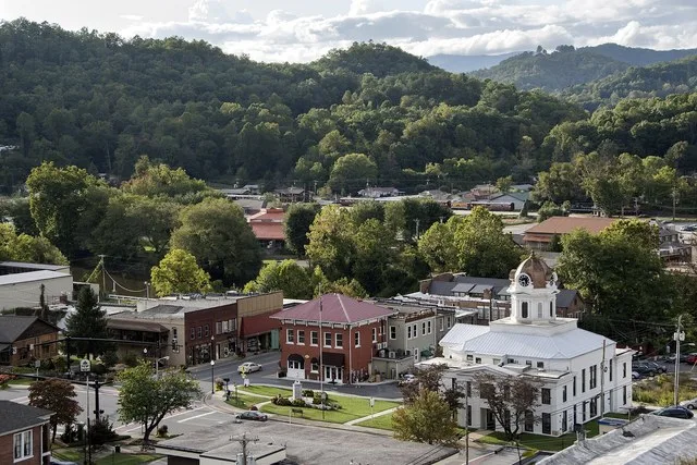 Downtown Bryson City, featuring the historic Swain County Courthouse, now a visitor center and heritage museum. The Great Smoky Mountains National Park highlights the mountains on...