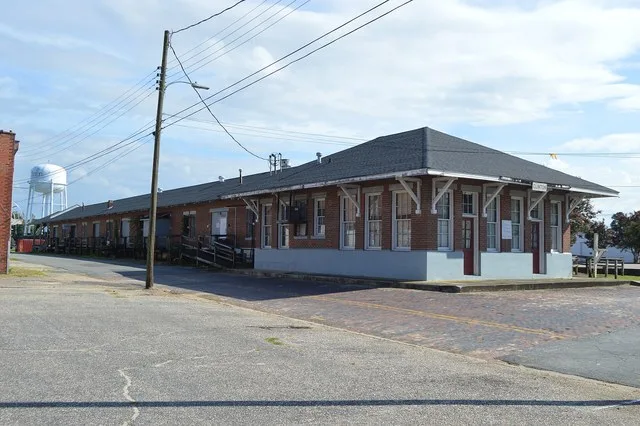 Front and northeastern side of the Clinton Depot , located on W. Elizabeth Street in Clinton , North Carolina , United States . Built in 1926, it is listed on the National Registe...