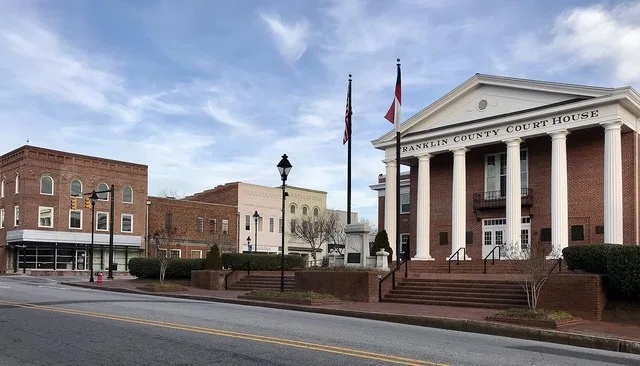 Franklin County Courthouse in Louisburg with commercial buildings on Nash Street in the background