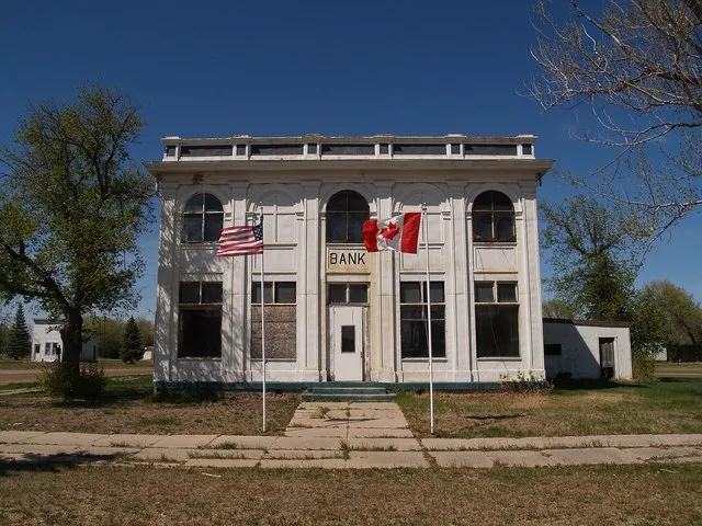 2nd view of the customs house in Antler, North Dakota showing U.S. and Canadian flags.