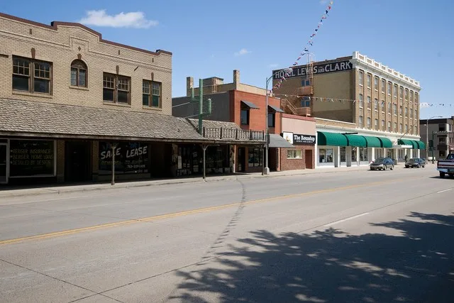 400 Block of W. Main Street in Mandan, North Dakota , part of the NRHP-listed Mandan Commercial Historic District . In the background at right is the NRHP-listed Lewis and Clark H...