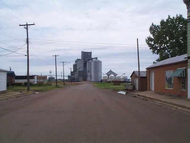 A view down the main road looking toward a grain elevator in New Leipzig, North Dakota.