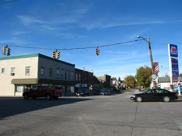 Photograph of the village of Attica , Ohio en , taken at ground level from South Main Street looking North toward the intersection of Ohio 4 and U.S. 224 .