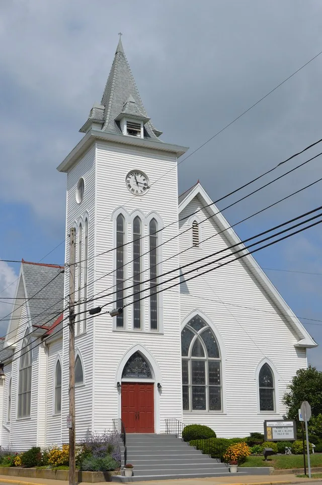Front of the Trinity United Church of Christ, located at the junction of Market ( State Route 256 ) and High Streets in Baltimore , Ohio , United States . It was built in 1899.