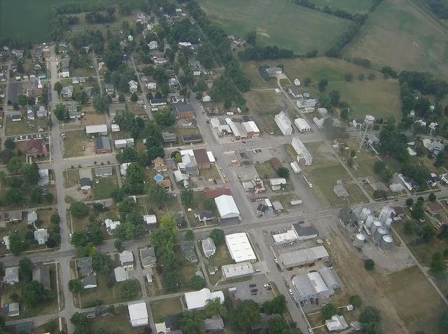 Aerial picture of the "downtown" area of Belle Center , Ohio , United States . Blur is a bug that was hit shortly after takeoff. Taken on June 25 , 2007 , from a Diamond DA20-C1 E...