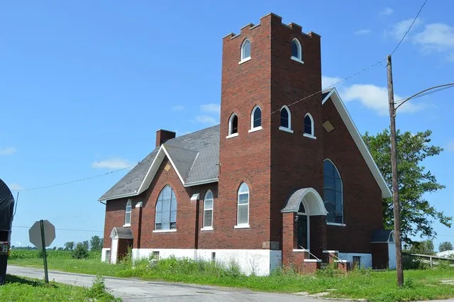 Front and eastern side of the former Golden Rule United Methodist Church ( United Brethren when built in 1931), located at the junction of Main and East Streets in Belmore , Ohio...