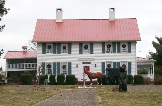 The Capt Jonathan Stone House in Belpre, Ohio. The home is photographed showing its southern facade. This side faces Blennerhassett Avenue and the Ohio River beyond. The house is...