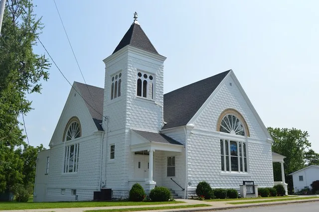 Front and eastern side of the Good Shepherd United Methodist Church , located at 119 W. Main Street (State Routes 12 / 235 ) in Benton Ridge , Ohio , United States .