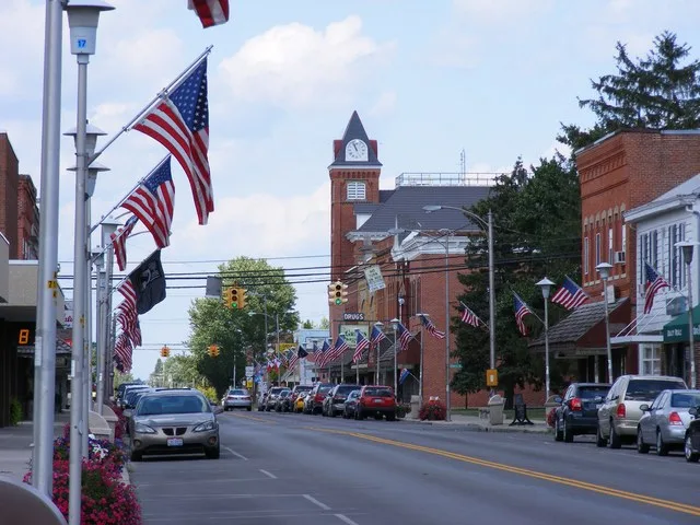 A look down Main Street in Bluffton, Ohio, including town hall and the American flags.