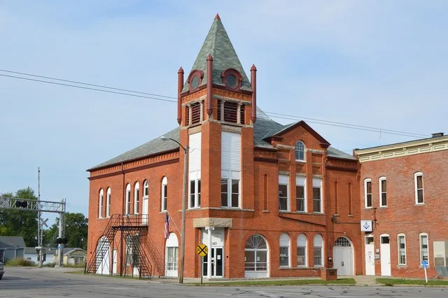 Front and western side of the Caledonia village hall, located on the northeastern corner of the public square in Caledonia , Ohio , United States .