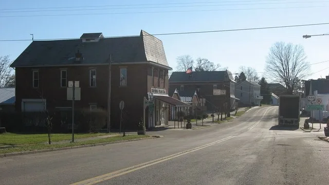Looking southward along Marion Street ( State Route 377 ) at the Mill Street ( State Route 555 ) intersection in Chesterhill , Ohio , United States . Among the buildings visible h...