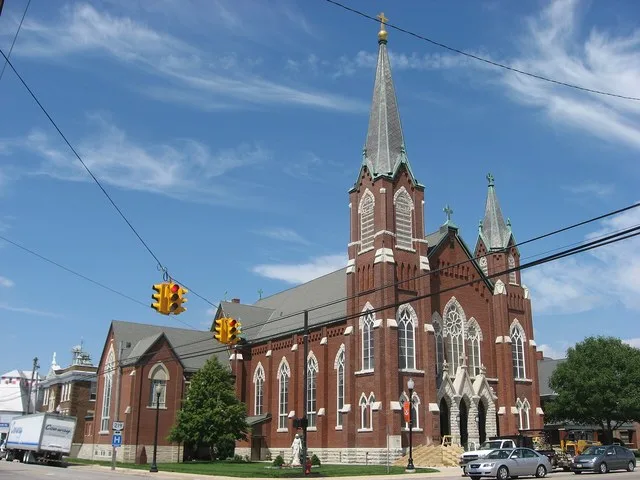 Front and western side of Holy Trinity Catholic Church , located at the intersection of Second ( State Route 118 ) and Main ( State Route 219 ) at the center of Coldwater , Ohio ...