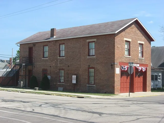 Front and northern side of the Covington Historic Government Building , located on the southeastern corner of the intersection of Spring and Pearl Streets in Covington , Ohio , Un...