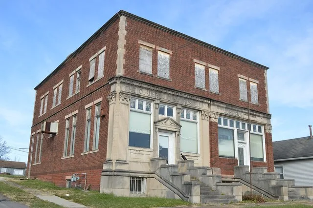 Western side and front of the former Cumberland Savings Bank (left side) and post office (right side), located on Main Street (State Routes 146 / 340 ) at Bank Street in Cumberlan...