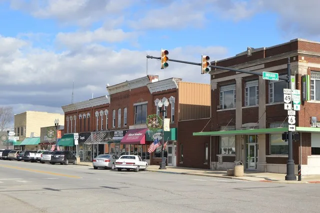 Buildings on the eastern side of Michigan Avenue ( State Route 49 ) at its intersection with Indiana Street ( U.S. Route 6 ) in Edgerton , Ohio , United States .