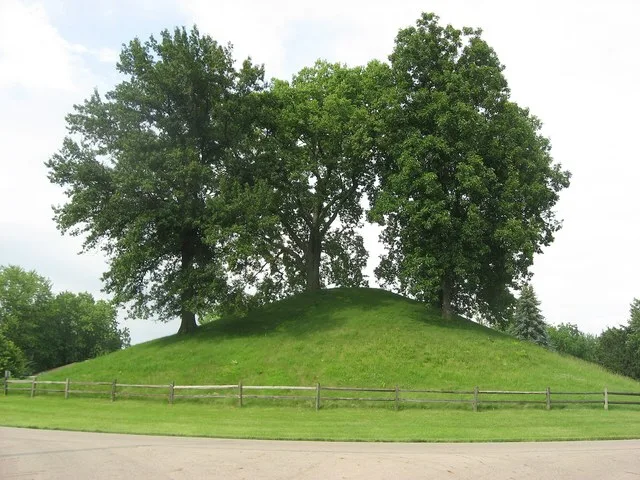 Western side of the Enon Mound , located inside of Mound Circle in Enon , Ohio , United States . Built by the prehistoric Adena culture , it is listed on the National Register of...