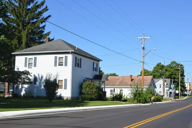 Houses on the southern side of Main Street ( U.S. Route 36 ) east of the Walnut Street intersection in Fletcher , Ohio , United States .