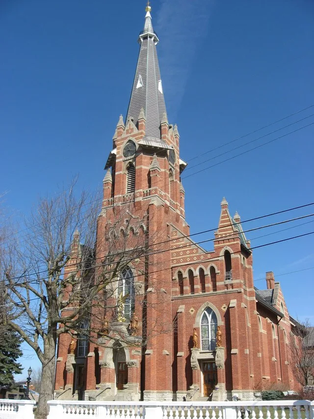 Front and eastern side of St. Michael's Catholic Church , located along State Route 705 east of its junction with State Route 66 in Fort Loramie , Ohio , United States . Note the...