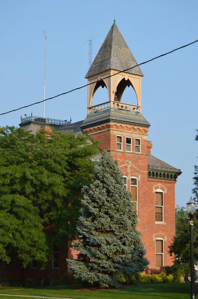 Front of the Genoa Town Hall , located on the southeastern corner of the junction of Sixth and Main Streets in Genoa , Ohio , United States . Built in 1885, it is listed on the Na...