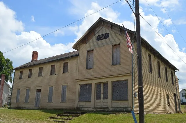 Front and western side of the former Gratiot IOOF lodge building, located at the intersection of Main and Center Streets in Gratiot , Ohio , United States .