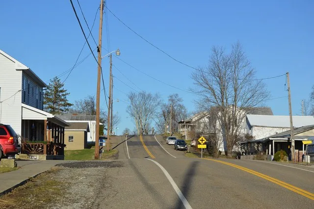 Looking northward along State Route 26 in Graysville , Ohio , United States . With fewer than one hundred residents, the village functionally has no other streets.