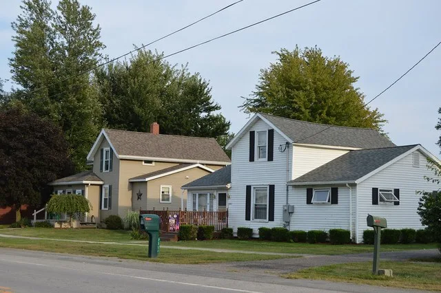 Houses on the southern side of Main Street ( State Route 294 ) just west of the Oneida Street intersection in Harpster , Ohio , United States .