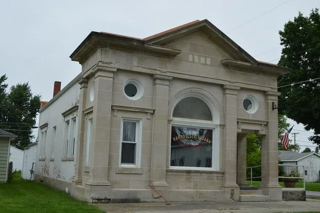Front and southern side of the former Harrod State Bank (now the local historical society), located at 100 S. Main Street in Harrod , Ohio , United States . It was built in 1910.
