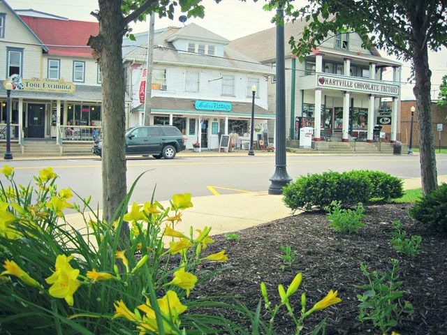 Historic buildings in Downtown Hartville, Ohio feature small businesses - Hartville Tool Exchange, Modern Vintage, and Hartville Chocolate Factory.
