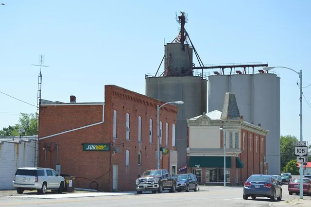 Commercial buildings and the community grain elevator, seen looking down Wilhelm Street ( State Route 108 ) from the Elm Street intersection in Holgate , Ohio , United States .