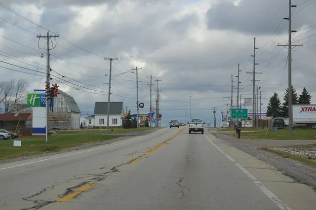 Looking northward in U.S. Route 20 Alternate/ State Route 15 in Holiday City , Ohio , United States . Most of the village consists of farmland, and this area is typical of the rem...