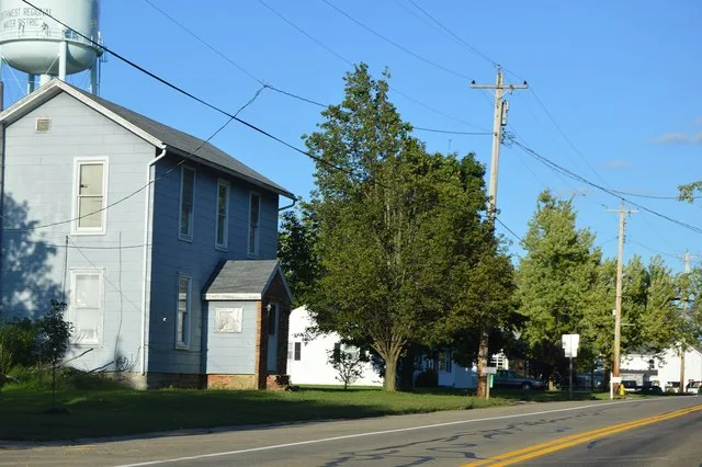 Houses on the northern side of State Route 744 at the western edge of Jacksonburg , Ohio , United States .