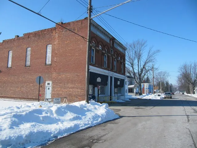 Photograph of the village of Jerry City , Ohio en , taken at street level from Main Street, looking West toward the local office of the United States Postal Service en .