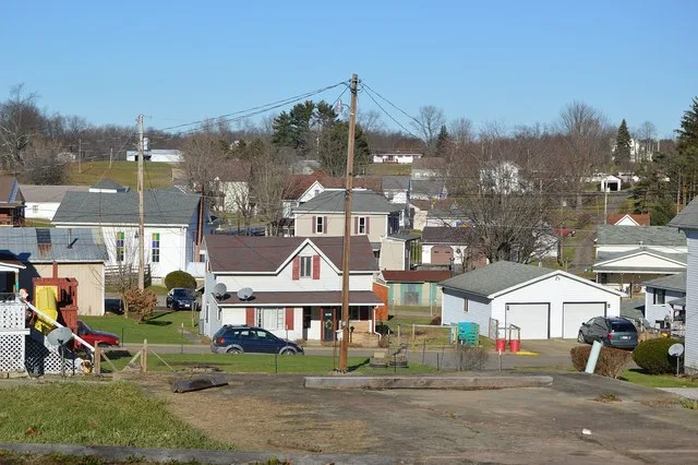 Looking north from Back Street over houses and a church on Railroad Street and Shenandoah Trail in Lewisville , Ohio , United States .