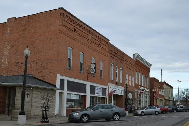 Buildings on the western side of East Street ( State Route 109 ) north of the Maple Street intersection in downtown Liberty Center , Ohio , United States .
