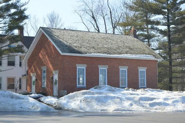 Northern side and front of the Old Euclid District 4 Schoolhouse , located on the western side of Richmond Road ( State Route 175 ) at the Oakmont Drive intersection in Lyndhurst...