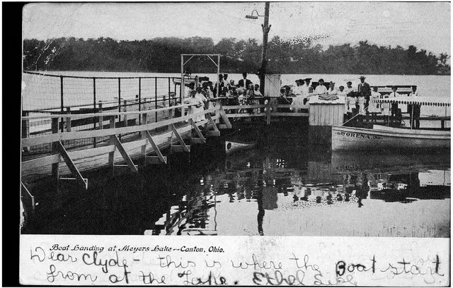 Photographic view of the boat docks at Meyers Lake, showing people and a boat "Orena".