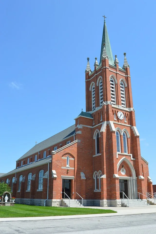 Western side and front of St. Nicholas' Catholic Church, located at 200 Main Cross Street in Miller City , Ohio , United States .
