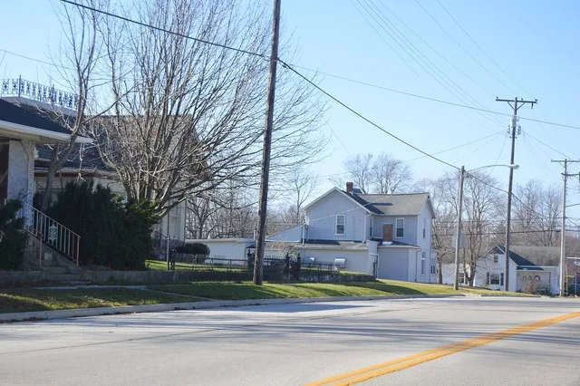Houses on the southern side of Main Street ( State Route 219 ) west of the High Street interection in Montezuma , Ohio , United States .